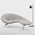 Modern Curved Light Green Sofa With Sleek Lines and Floor Lamp in Minimalist Interior