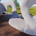 Modern Outdoor Children's Play Area With Curved White Structure Green Grass And Wooden Floor
