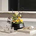 Black Vase With Yellow Flowers Green Foliage And Dark Berries On Marble Countertop