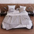 Double Bed With Brown Upholstered Headboard White Pillows Gray Cushions Gray Knitted Blanket And Black Nightstands