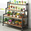 Multi Tier Rolling Plant Stand With Colorful Potted Flowers And Green Plants For Indoor Garden Decor