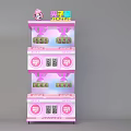 Pink Two Tiered Claw Machine With Cartoon Decoration On Top And Coin Slots
