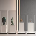 Antique Exhibits in Transparent Display Cases on White Pedestals Against Gray Wall Background