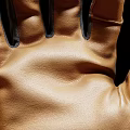 Pair of Brown and Black Leather Fabric Gloves With Detailed Stitching And Wrist Cuffs