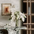 Transparent Glass Vase With White Orchids And Flowers On Marble Tabletop In Modern Interior