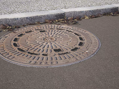 Urban Road Facilities Circular Manhole Cover on Asphalt Surface with Cobblestone Pavement and Curb 3d model