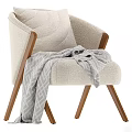 Modern Neutral Upholstered Armchair With Wooden Arms And Gray Throw Blanket