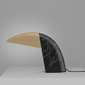 Modern Curved Table Lamp With Black Marble And Beige Accents On White Surface