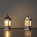 Two Classic Outdoor Lanterns With Decorative Tops And Lit Glass Panels