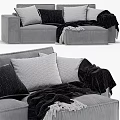 Modern Gray Sofa With Pillows And Blanket And Comfortable Bed With Purple Quilt