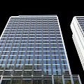 Modern Tall Office Building Exterior With Glass Curtain Walls And Large Windows