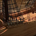 Wooden Sailboat Model With Multiple Sails And Detailed Hull On Indoor Floor