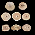 Seven Different Shaped Wooden Stump Clocks With Metal Hands On Black Background