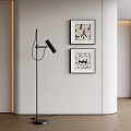 Framed Abstract Paintings Hanging On Wall In Modern Interior With Black Floor Lamp