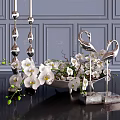 Decorative Ornament Set With White Orchids Silver Swan Figurines Metallic Candle Holders On Black Table