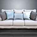 Cream Fabric Sofa With Rolled Arms Dark Wooden Legs And Gray Light Blue Throw Pillows