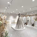 Elegant Bridal Shop with Grey Lace Wedding Dress on Display Platform and Hanging Bridal Gowns