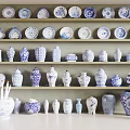 Blue and White Ceramic Vessels with Traditional Patterns Displayed on Shelves