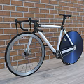 Stylish White Frame Bicycle With Blue Wheel Against Brick Wall And Wooden Floor