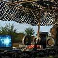 Natural Outdoor Scenery With Camouflage Shelter Sandbags Tires Metal Barrels Trees And Grassland