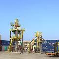 Yellow Industrial Equipment With Multi Level Steel Platforms And Metal Ladders At Container Site