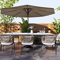 Outdoor Wicker Table And Chair Set With Large Umbrella And Green Plants