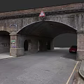Brick Arch Underpass With Multiple Arches Road Red Car Graffiti And Warning Sign