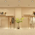 Clothing Store Display With Hanging Clothes Gold Racks Beige Walls Ceiling Lights and Potted Plant