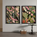 Two Framed Decorative Paintings With Pink Flowers Green Leaves And Small Table With Candles
