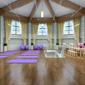 Indoor Yoga Fitness Studio With Purple Mats Wooden Floor And Stone Walls