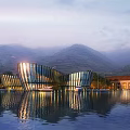 Modern Glass Building With Waterfront Reflection And Mountain Background At Dusk