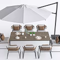 Stylish Outdoor Dining Chairs With Woven Seats Metal Frames And Large Umbrella Table