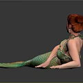 Red Haired Woman In Green And Yellow Mermaid Tail Lying On Black Smooth Surface
