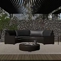 Outdoor Wicker Sofa With Gray Cushions Round Coffee Table And Green Plants By Stone Wall