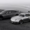 High Performance Sports Cars Parked Side by Side on Open Road With Coastal View