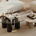 Stylish Glass Top Coffee Table With Black Cylindrical Legs And Decorative Tray Items