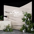 Luxe Check in Photo Spot With Beige Pleated Backdrop Green Plants And White Flowers