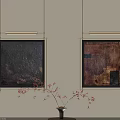 Abstract Paintings on Beige Wall with Metallic Frames and Decorative Vase with Thin Branches