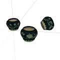 Three Black Ceramic Jars With Green Vine Patterns On White Background
