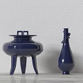 Two Blue Ceramic Vessels Tripod Cauldron And Slender Bottle On Light Tabletop With Wall Background 3d model