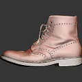 Tan Leather Brogue Ankle Boots With Intricate Lace Up Design On Reflective Surface