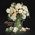 Transparent Glass Vase with Hydrangea White and Cream Flowers Green Leaves and Petals Scattered Around