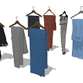 Stylish Assorted Color Pants Hanging On Wooden Hangers With Different Textures And Casual Styles