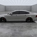 Sleek White Sedan With Black Wheels In Modern Indoor Display Room