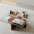 Glass Top Coffee Table With Wooden Legs Open Book Candles And Tray On Carpet
