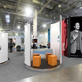 Modern Exhibition Booth Design With Modular White Orange Panels And Interactive Visitor Areas