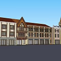 Hotel Building with Twin Orange Spires Classical Style Arched Entrance Adjacent Red Roof Buildings
