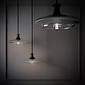 Three Modern Glass Pendant Lights With Black Base Hanging In Dark Background Emitting Soft Light 3d model
