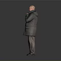 Bald Man Adjusting Collar Of Dark Coat Standing Against Gray Background