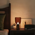 Warm Light Table Lamp On Bedroom Bedside Table With Astronaut Figurine Radio And Picture Frame
